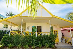 a yellow house with a yellow roof at Beachfront Villa with Sunset in Ban Bang Po