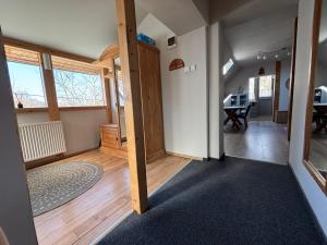 a room with a hallway with a door and a table at Pioppo Apartman in Tiszavasvári