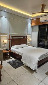a bedroom with a large bed and a fireplace at Balaji Hotel and Resturant in Kolaghat