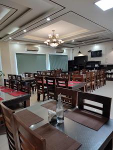a dining room with wooden tables and chairs at Foxoso Heights, Tapovan in Rishīkesh