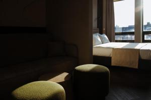 a hotel room with a bed and a couch and a window at Ferdinand Boutique in Cluj-Napoca +74 photos