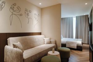 a living room with a couch and a bed at Ferdinand Boutique in Cluj-Napoca