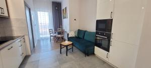 a kitchen and a living room with a couch and a table at Apartament 39 in Lublin