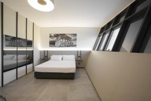 a bedroom with a bed and a large window at CUBIK inn Design Rooms in Gravina di Catania