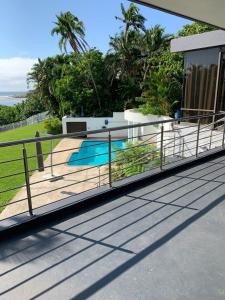 a metal railing on a roof with a swimming pool at Villa Aurora in Margate