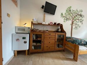 a room with a cabinet and a microwave and a refrigerator at U Sovičky in Olešník