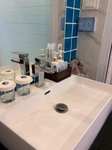 a bathroom counter with a white sink at Deco Harmony Pattaya 1 in North Pattaya +16 photos