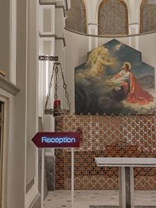 a bench in a room with a painting on the wall at Safestay Naples Materdei in Naples