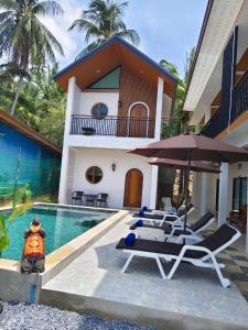 a villa with a swimming pool and a house at Lanta Daisy Residence in Ko Lanta