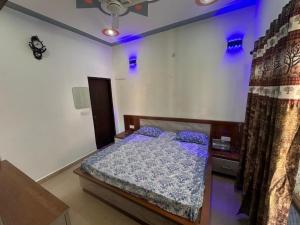a bedroom with a bed in a room with blue lights at Mountview guest house in Mukteshwar