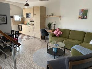 a living room with a couch and a table at Ferienhaus Dresden in Dresden