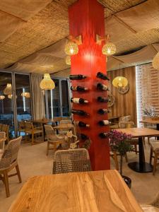 a wine rack with wine bottles in a restaurant at Blumont aparthotel durres in Durrës