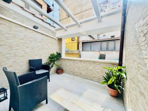 a balcony with chairs and plants in a building at Luxury Allegra’s home in Syracuse