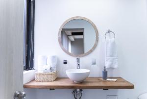 a bathroom with a sink and a mirror at Hotel Bambu Milla De Oro in Medellín +36 photos