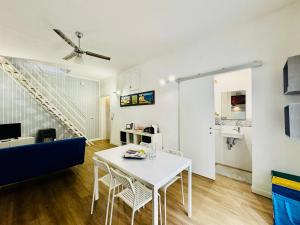 a living room with a white table and a blue couch at Luxury Allegra’s home in Syracuse