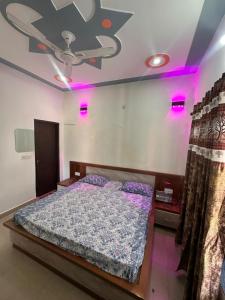 a bedroom with a bed with purple lights on it at Mountview guest house in Mukteshwar +47 photos