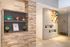 a lobby with a wooden wall with flowers on it at A Hotel Joo Chiat in Singapore