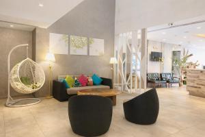 a living room with a couch and chairs at A Hotel Joo Chiat in Singapore +105 photos