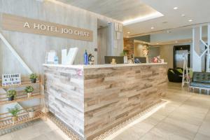 a hotel lobby with a hotel logo on the wall at A Hotel Joo Chiat in Singapore