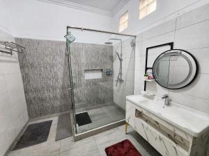 a bathroom with a shower and a sink and a mirror at Kulem Gempol in Bandung +29 photos