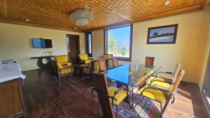 a room with a table and chairs in a room at Grand Mumtaz Tangmarg in Tangmarg