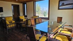 a conference room with chairs and a glass table and a table and chairsktop at Grand Mumtaz Tangmarg in Tangmarg