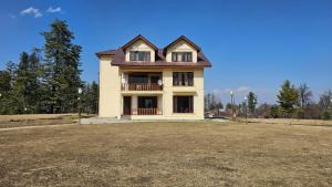 a large house with a large yard in front of it at Grand Mumtaz Tangmarg in Tangmarg
