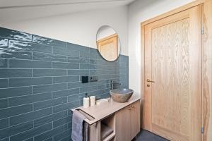 a bathroom with a sink and a mirror at Dunique Summer in Palanga +19 photos