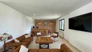 a living room with a couch and a table at L'Echo du Bonheur in Vaumas