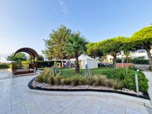 a garden with a playground in a park at Ashanti Aparthotel Wellness&Spa in Bibione