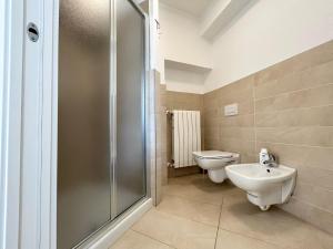 a bathroom with a shower and a toilet and a sink at Relax Home in Clusone +6 photos