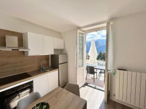 a kitchen with a table and a view of a patio at Relax Home in Clusone