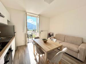 a living room with a couch and a table at Relax Home in Clusone