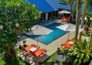 an overhead view of a pool with chairs and umbrellas at Phuket Airport Hotel in Nai Yang Beach +35 photos
