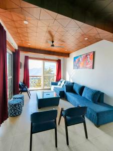 a living room with a blue couch and chairs at Opal Villas Mussoorie near Mall Road in Mussoorie