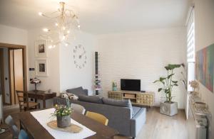 a living room with a couch and a table at La Casa di Emy in Solto Collina