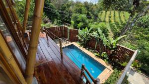 an overhead view of a swimming pool on a wooden deck at Villa Bambu Juma & Bakal in Kotasuka