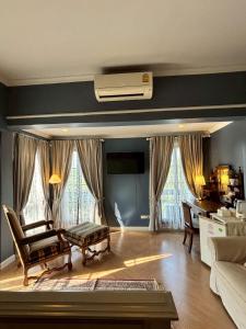 a living room with a couch and a table at Maison Dang Boutique Hotel in Chiang Mai