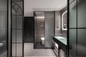 a bathroom with a toilet and a sink and a mirror at 总统號外酒店 President HaoWai Hotel Guangzhou in Guangzhou +75 photos