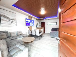a living room with a couch and a table at Davon- Doña Soledad in Polon