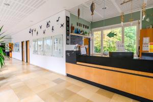 a restaurant with a counter with birds on the wall at Jugendherberge Otto-Moericke-Turm in Konstanz