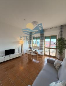 a living room with a couch and a table at Etruscan Blue House in Piombino