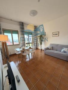 a living room with a couch and a table at Etruscan Blue House in Piombino