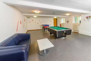 a living room with a pool table and couches at Jugendherberge Otto-Moericke-Turm in Konstanz
