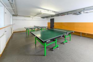 a room with four ping pong tables in it at Jugendherberge Otto-Moericke-Turm in Konstanz +9 photos