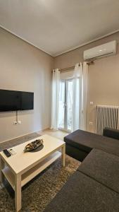 a living room with a couch and a coffee table at Efrosini's by the sea apartment in Chalkida