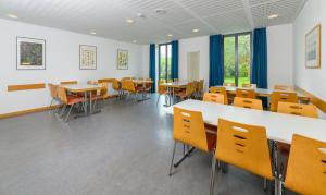 a room with tables and chairs in a classroom at Jugendherberge Otto-Moericke-Turm in Konstanz