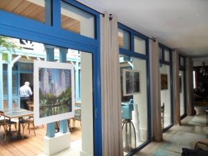 a room with windows and a man standing in a room at Villa d'Eaux in Villers-sur-Mer