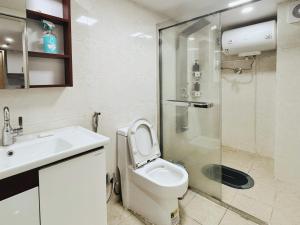 a bathroom with a toilet and a sink and a shower at 泊金青年旅舍-深圳北站店 in Shenzhen