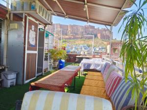 a balcony with benches and a view of a harbor at Shivam Guest House in Jodhpur